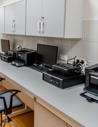 Consulting image office setup with printers, monitors, desktops, UPS, and more.
